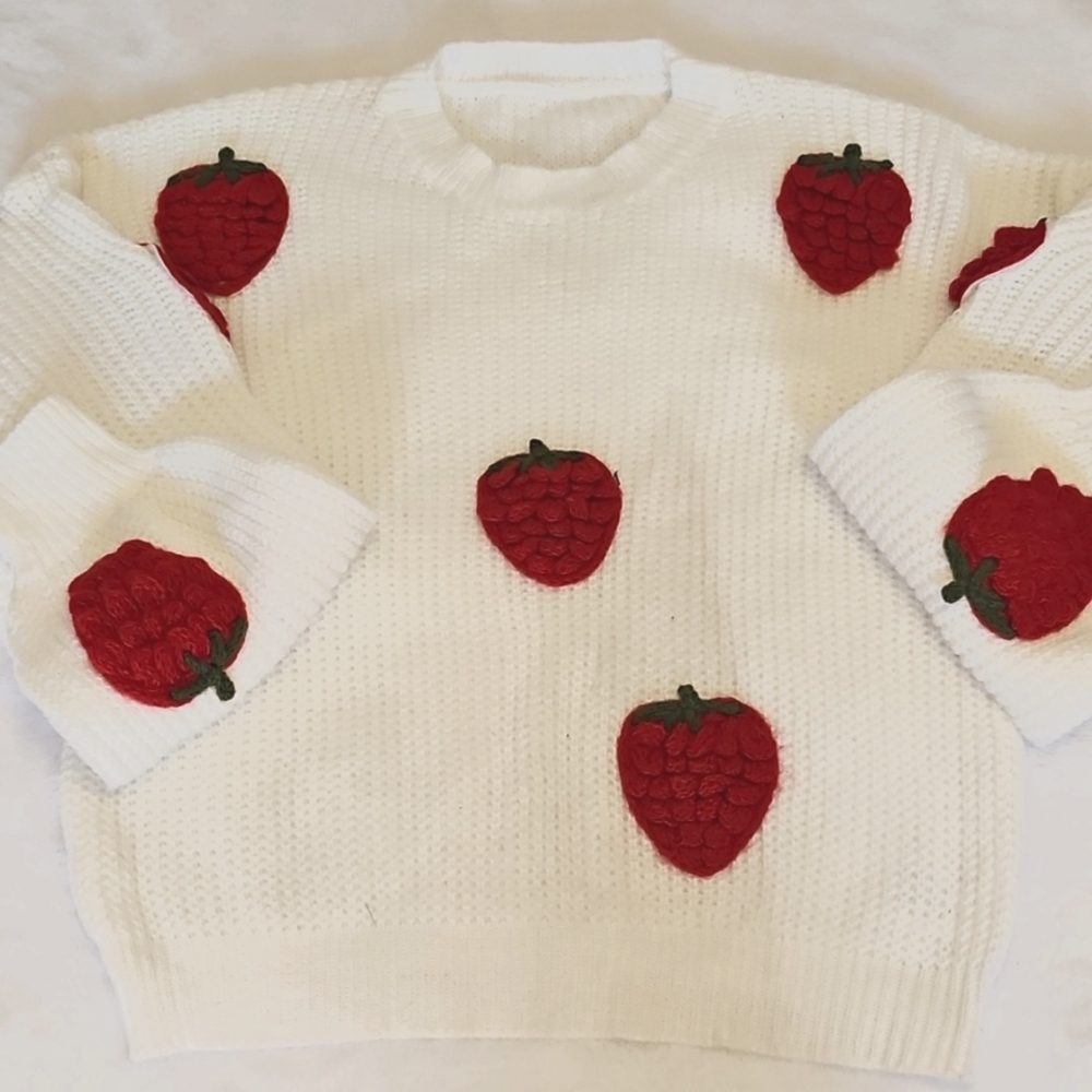 Cable knit white sweater with strawberries on it. Very cute!